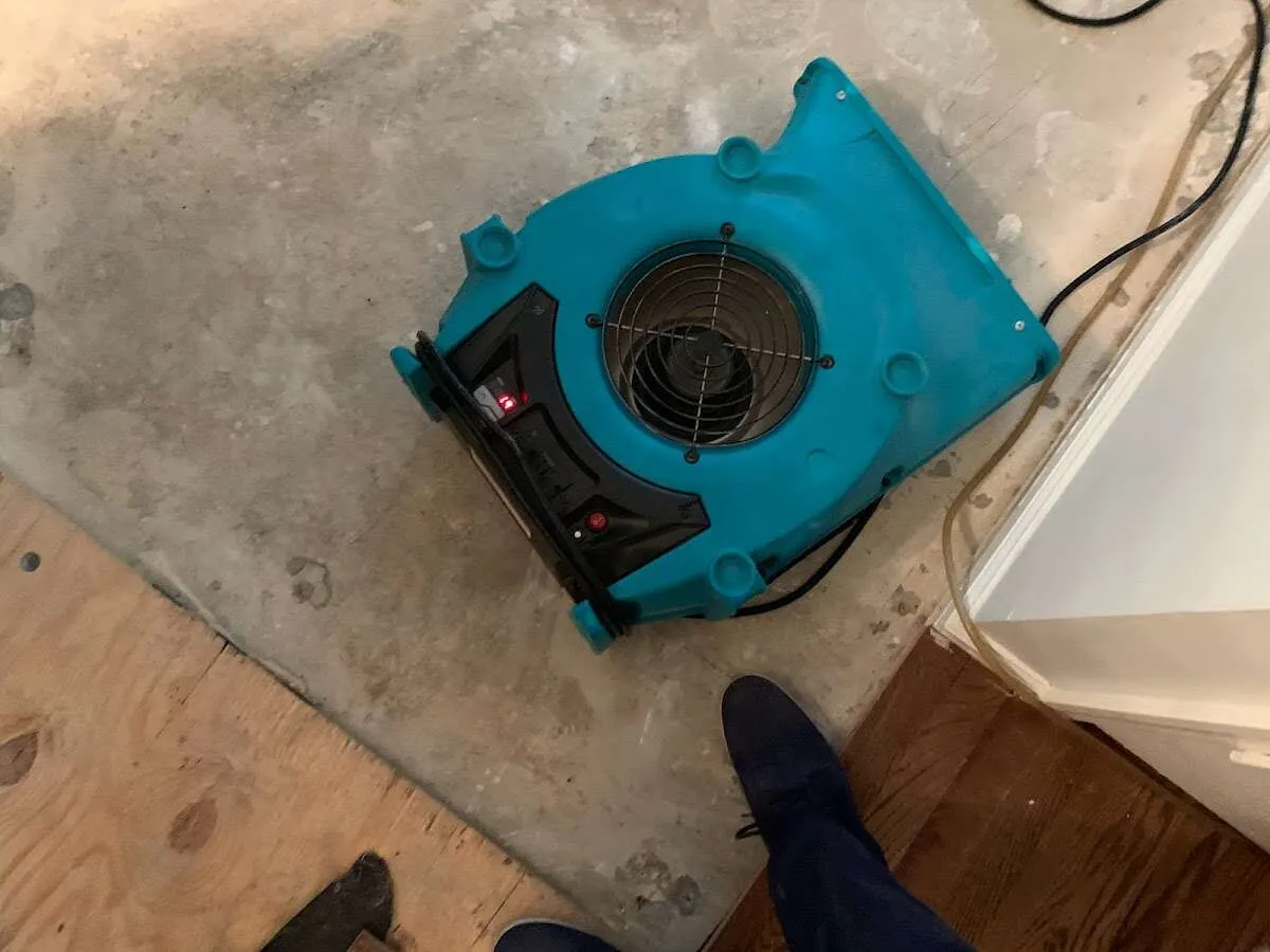 Air mover drying subfloor during Commercial Water Damage Restoration in Parker